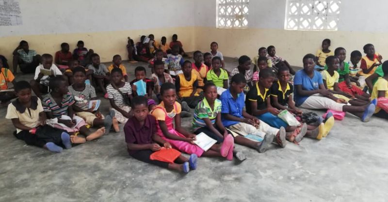 Older children sitting on the classroom floor