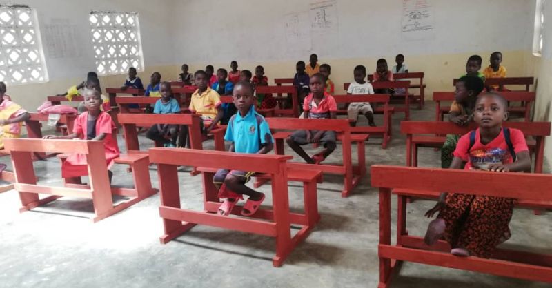 Children sitting on the desks