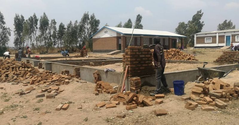 Overview of the building site in front of existing school