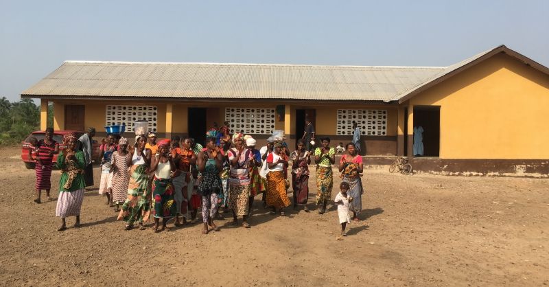 Women singing in front of school