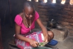 A girl cutting vegetables into small pieces  