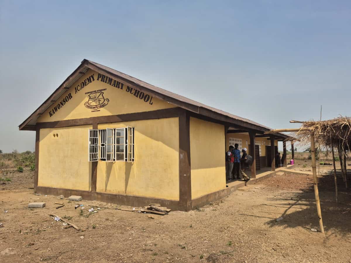 Kwonosor Academy Primary School in Gambia, with children outside in sunny weather.